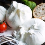 Appetizing burrata cheese with tomato and bread