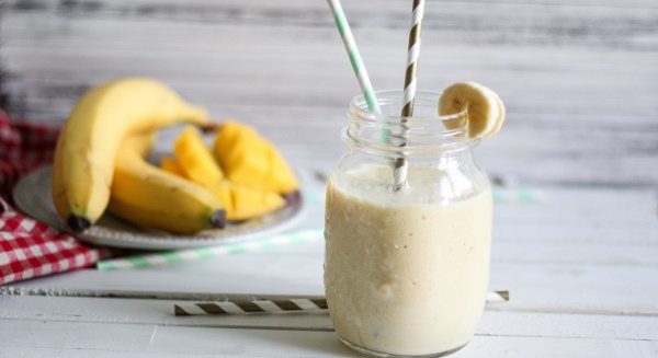 Banana smoothie in a blender. Recipes with milk, oatmeal, kefir, ice cream, cocoa, cream 